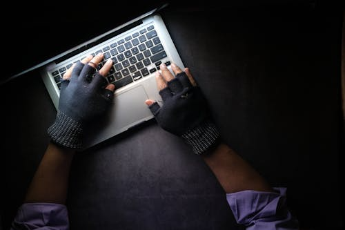 A person using a laptop in the dark
