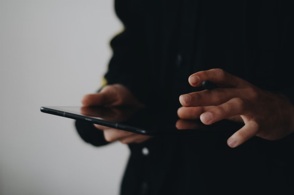 A person using a tablet computer at a desk.