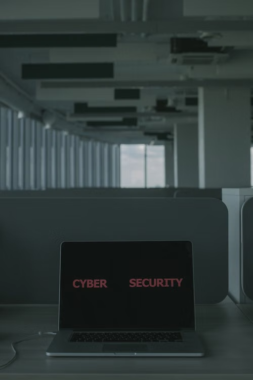 A laptop screen displaying the words "cyber security."