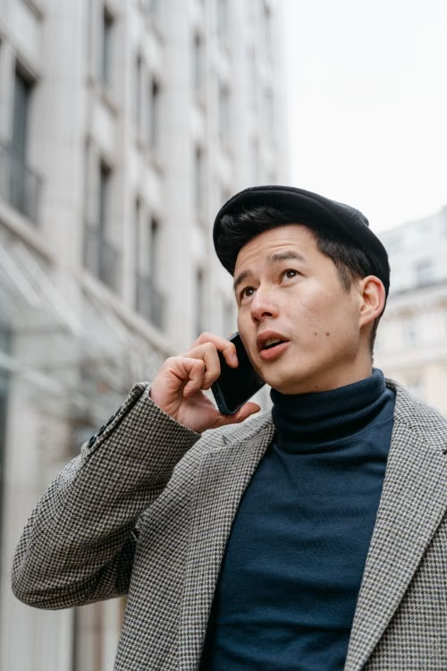 Man on a phone call representing a fraudulent bank security alert scam